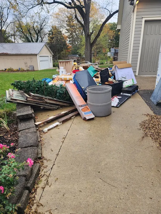 Dumpster being loaded with debris for 12 Yard Dumpster Rental in Moose Lake